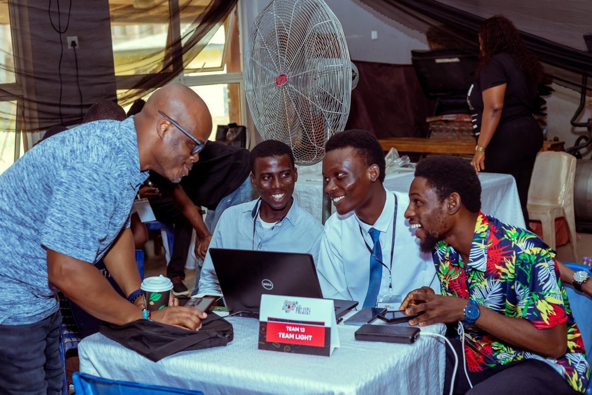 Mobolaji working through a build with a team at a 234 Project hackathon